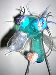 This sculpture is made of plastic, glass, tin and lead. It's on his way to give his heart away to someone he loves..