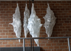 Industrial shrink wrap and used glassware forced into a object.