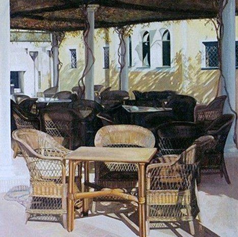 Terras met rieten stoelen