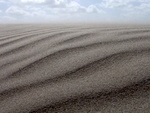 een serie foto's met als thema zand en water van de kust.