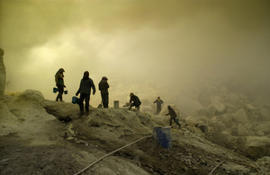 At volcano-rich Java, Kawah Ijen distinguishes itself from other volcanoes by a crater lake with an extremely high acid-level. Constant rising sulphur fumes are melted and guided outside by pipelines. Consolidated as yellow substance, porters are hauling the sulphur-containing chunks up the rim of the crater and from there downwards off the volcano to a weigh station. Making two trips a day this exhausting and unwholesome work yields a porter a poor income.