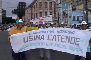 Brazil is the world's greatest producer of sugar. Enormous areas are covered with industrialized sugar cane growing and huge sugar factories. Usina Catende is the exception. It is organized as a small sugar coöperative based on solidarity of sugarcane growers and factory workers, with respect for the local environment. Demonstrations, meetings and discussions are part of their struggle to survive