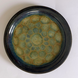 These plates and mugs have both a decorative and utility function. The glaze is food-safe and they are dishwasher-safe.