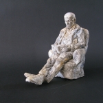 Lezende man in fauteuil