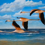 Flamingo's viegend langs de vloedlijn