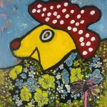 Dog in flowerfield with a mushroom hat