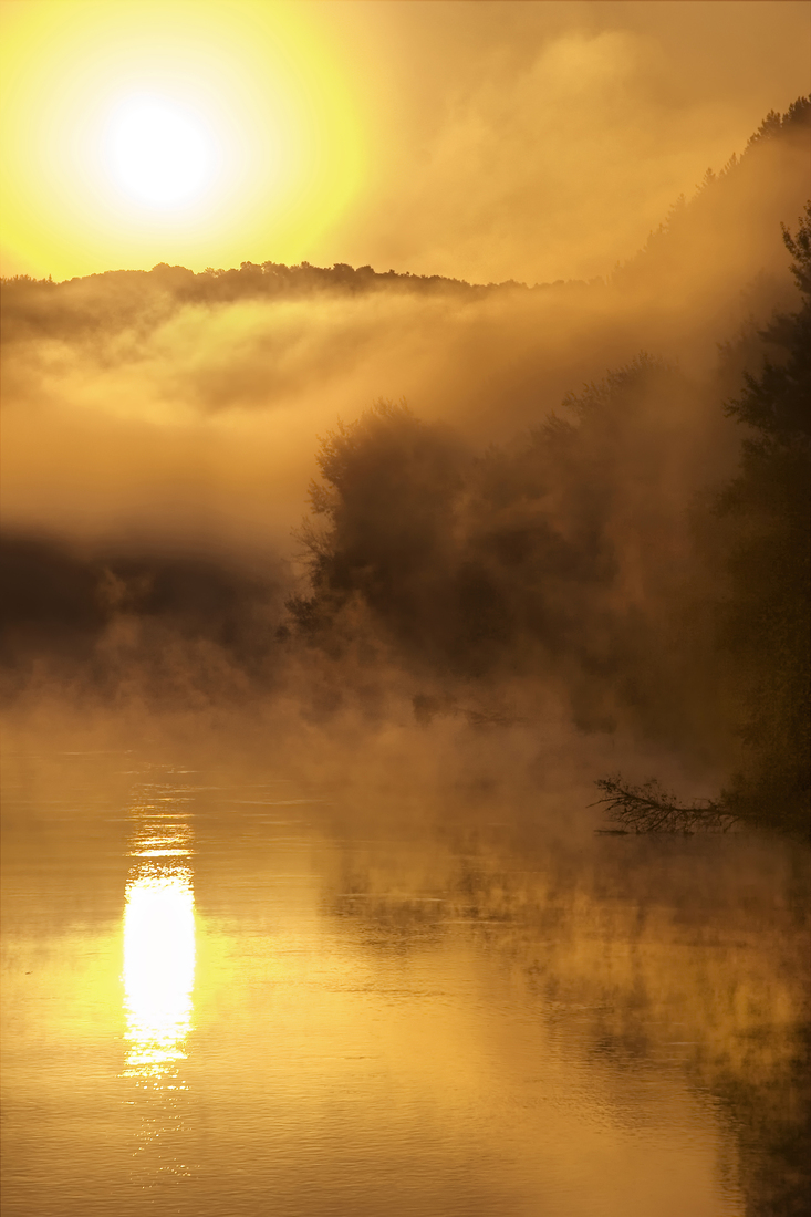 Dawn over the misty river