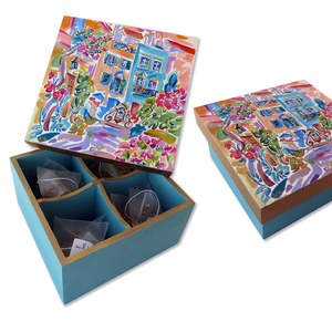 The ‘Happy Art Tea Boxes’ are handmade and have a ‘Happy Watercolors’ Art print that is partially hand painted which makes each box unique. The wooden box is painted in a mat color with ‘liquid gold’ accents.