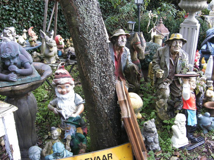 Two old men and a smiling donkey in the woods