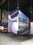 Installatie van fotowerken op doek. Fotocollage met schilderijen, getoond in de Wennekerfabriek Roosendaal