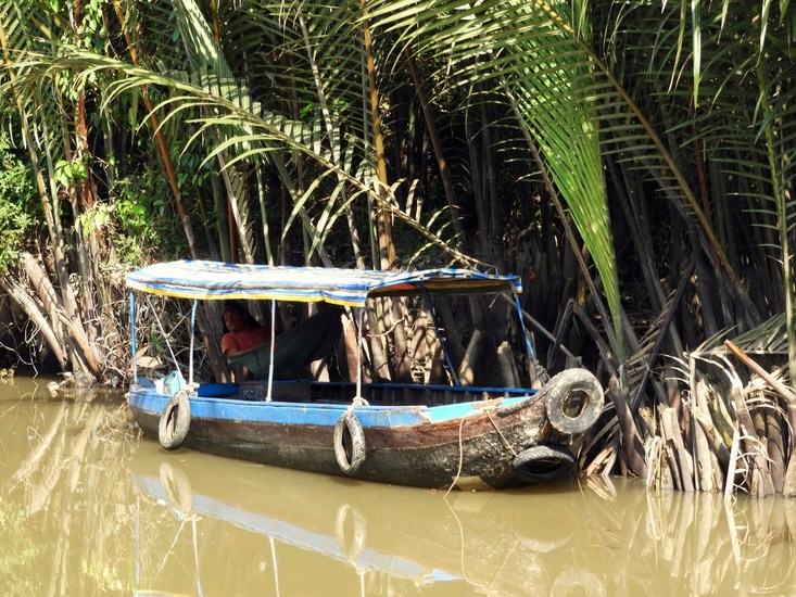 sleeping in a boat on the Mekong