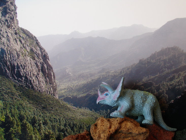 dinosaur climbing rocky ridge