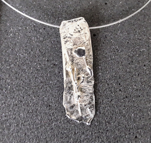 De zilveren hangers zijn uitgevoerd in diverse technieken. De hangers kunnen gedragen worden aan een rubberkoord, staaldraad of ketting. 