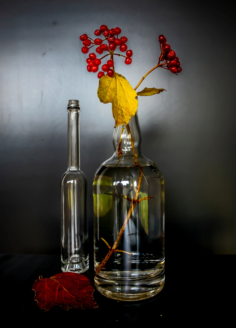 Still life with two vases and an autumn leaf