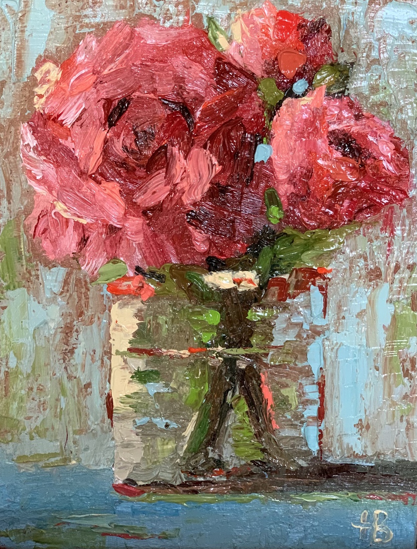 Rode rozen in een glazen vaasje.